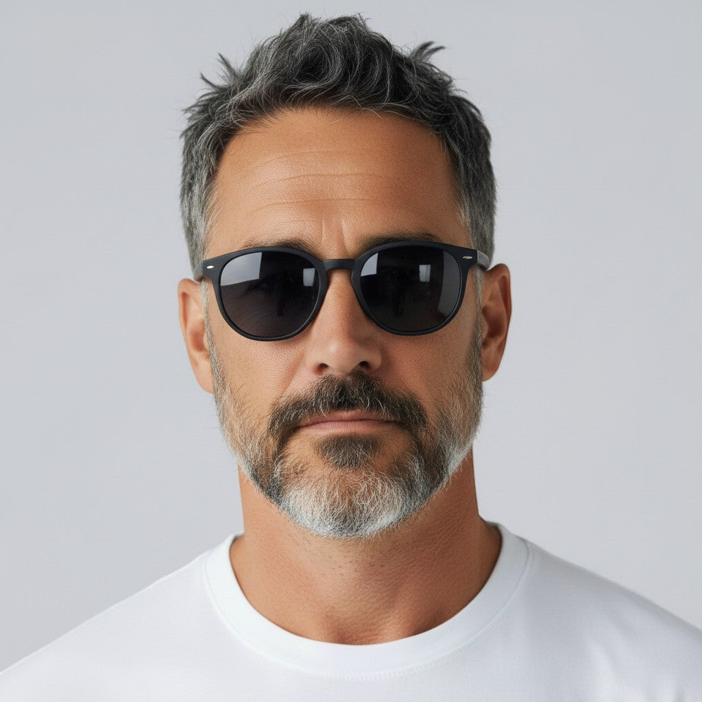 W One Brand Store retro black acetate sunglasses with dark grey lenses on a man with grey hair and beard.
