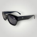 W One Brand Store black acetate cat-eye sunglasses with dark grey lenses and subtle 'W' logo detail.