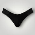 W One Brand Store black seamless thong with lace sides, made of polyamide and elastane blend.