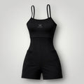 W One Brand Store black polyamide fitness romper with spaghetti straps and side pockets, ideal for workouts.