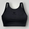 W One Brand Store black polyamide sports bra with X-back design and subtle embroidered logo, ideal for fitness.
