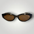 W One Brand Store mini cat-eye sunglasses in translucent brown-green acetate with brown lenses and subtle stud details.