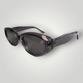 W One Brand Store cat-eye sunglasses in translucent grey acetate with dark grey lenses and a subtle 'W' logo detail.