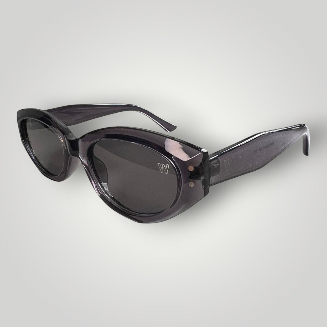 W One Brand Store cat-eye sunglasses in translucent grey acetate with dark grey lenses and a subtle 'W' logo detail.