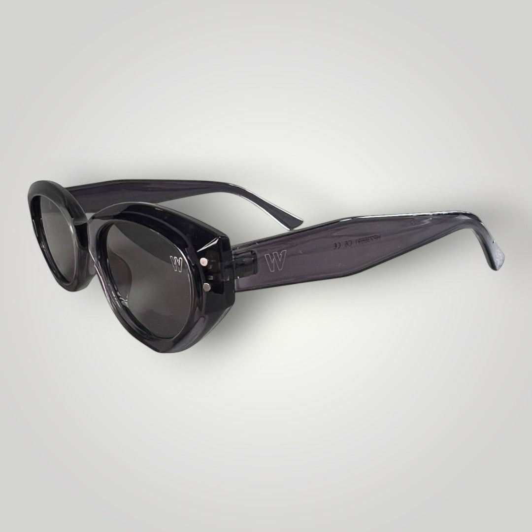 W One Brand Store translucent grey cat-eye acetate sunglasses with smoke lenses and silver stud details.