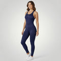 Modelo vestindo macacão fitness W One Brand Store azul marinho com modelagem sculpt e tecido de média compressão