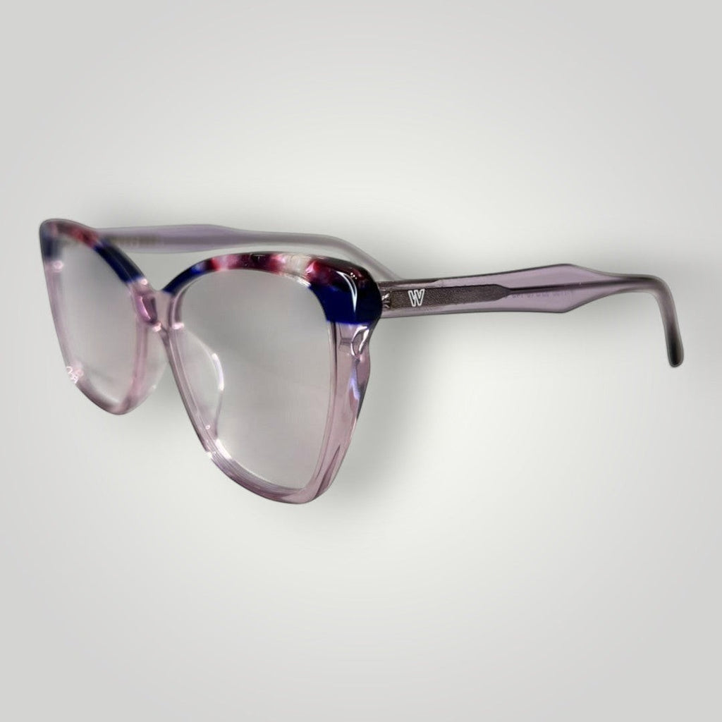 Óculos de grau W One em acetato lilás com detalhes superiores e pontas das hastes fumê, armação moderna e elegante.
