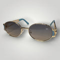 Óculos de Sol Oval Premium Dourado com Detalhes Azuis e Lentes Azuis vista frontal