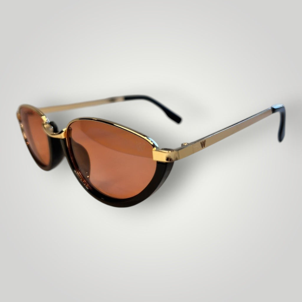 Óculos de sol W One dourados com armação oval em metal e acetato preto, lentes rosas e proteção UV400.