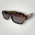 W One Brand Store rectangular acetate sunglasses with camouflage pattern and brown gradient lenses. Features a gold accent on the temple.