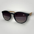 W One Brand Store retro round acetate sunglasses in black with gradient dark lenses and light brown temples. Features UV400 protection.