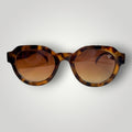 W One Brand Store round acetate sunglasses with camouflage pattern and brown gradient lenses.