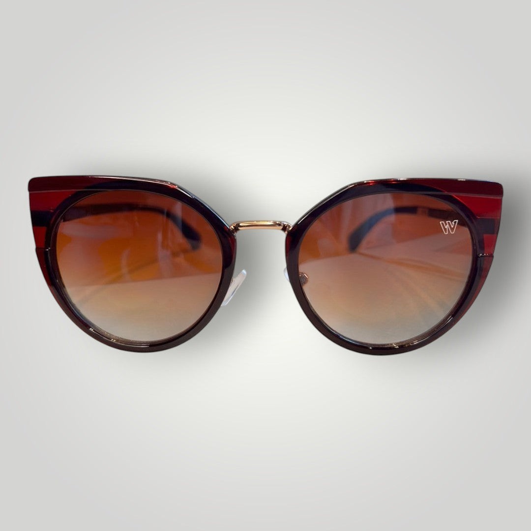 W One Brand Store cat-eye sunglasses in wine acetate with gold details and gradient brown lenses.